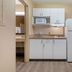 Extended Stay America Suites - Bakersfield - California Avenue kitchenette with fridge, microwave and cabinets