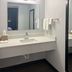 Studio 6 Huntsville. Al University Drive bathroom with vanity sink, mirror, towel rack and dark flooring in Huntsville