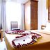 Tr Residency Pondicherry guest room with king bed, tufted headboard and rose petals on the bed