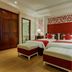 La Beaute De Hanoi Hotel in Hanoi: twin beds with red accents in a bright guest room