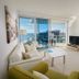 Nirvana By The Sea in Coolangatta, bright apartment with balcony ocean and city views, sofa and TV