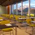 Thon Hotel Lofoten conference room in Svolvær with yellow chairs, tables, and mountain views through large windows