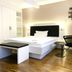 Zeitwohnhaus Suite-Hotel & Serviced Apartments in Erlangen bedroom with bed, bench, desk and chair