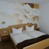 Hotel Dreikönig & Restaurant Seegourmet room with twin bed, floral mural and wall mirror in Hagnau am Bodensee