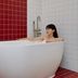 Nube Hotel & Spa Seoul Jongno bathtub in a tiled spa bathroom with a woman soaking
