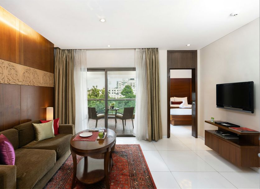 Oakwood Residence Naylor Road Pune suite with living area, balcony and city view, Pune