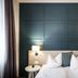 Post Hotel - Tradition & Lifestyle Adults Only in San Candido room with king bed, bedside lamps and dark paneled wall