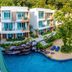 The L Resort, Krabi in Ao Nang with pool, sun loungers, and white guest buildings amid tropical greenery
