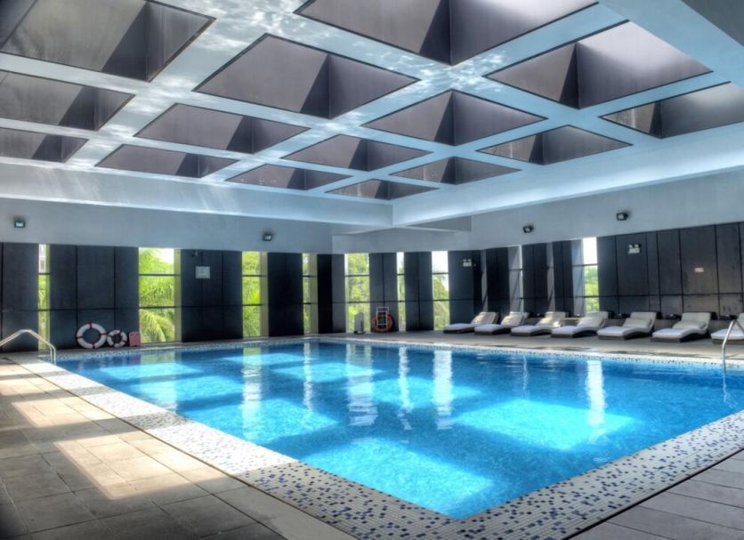 Zhuhai Zobon Art Hotel in Zhuhai indoor swimming pool with loungers and skylit ceiling