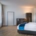 Hotel Ruf Pforzheim guest room with twin beds, desk, and modern wood flooring