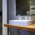 Cozy Hotel in Plouigneau bathroom with walk-in shower, sink, and wood countertop