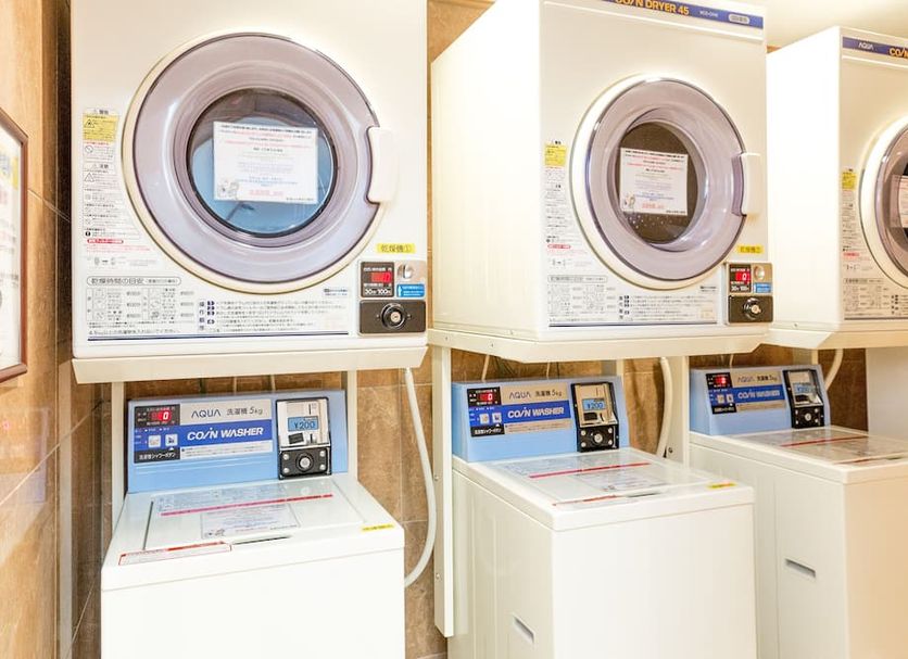 Toyoko Inn Tokyo Kamata Higashi-guchi in Tokyo laundry room with stacked washing machines and dryers