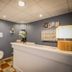 Abrivado hotel reception desk in Saintes-Maries-de-la-Mer with gray walls and checkered floor