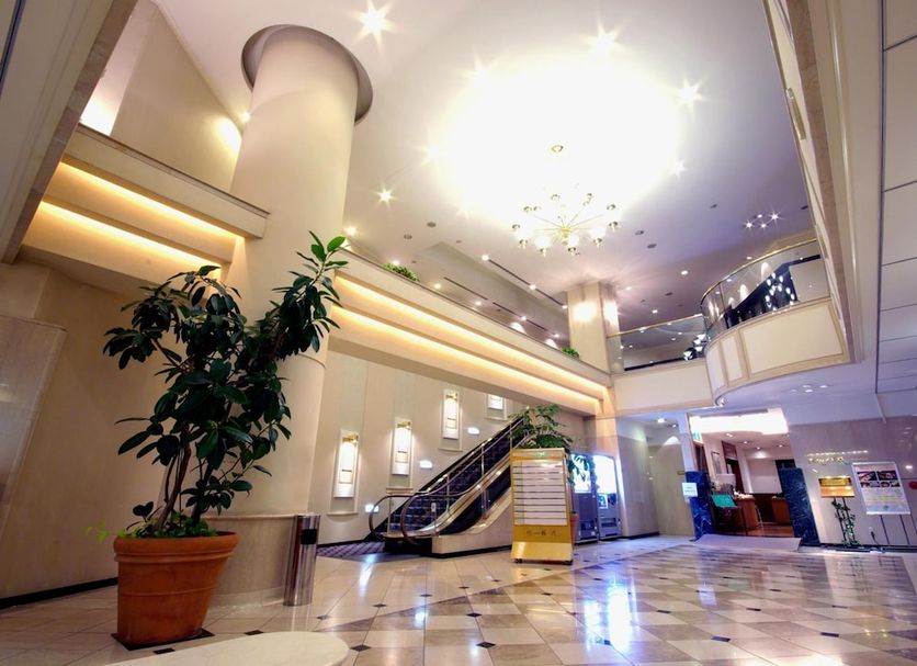 Sasebo Washington Hotel lobby with escalator, glossy marble floor, and high ceiling in Sasebo