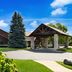 Best Western Northwoods Lodge in Siren with rustic lodge exterior, porte cochere, and evergreen landscaping