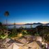 Hotel Club Marina Viva in Porticcio with terrace umbrellas, palm trees and bay sunset views