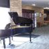 Asahikawa Park Hotel lobby with grand piano, brick columns, and seating area in Asahikawa