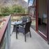 Shotover Lodge in Queenstown balcony with table, chairs, mountain view and open glass door