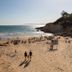 htop Molinos Park in Salou overlooking a sunny beach with sea, cliffs, and sun loungers