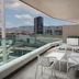 Four Points by Sheraton Izmir balcony with city and mountain views, glass railing and outdoor seating
