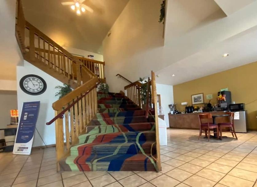 Rodeway Inn Salina North lobby with staircase, front desk and tiled floor in Salina