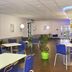 Ibis Budget Marne la Vallée lobby seating area in Saint-Thibault-des-Vignes with blue chairs and tables