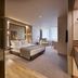 Portobay Teatro in Porto: modern guest room with bed, sofa, desk, and bathroom vanity