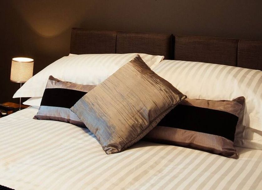 Seafield Arms Hotel, Banff: neatly made bed with striped bedding and decorative pillows