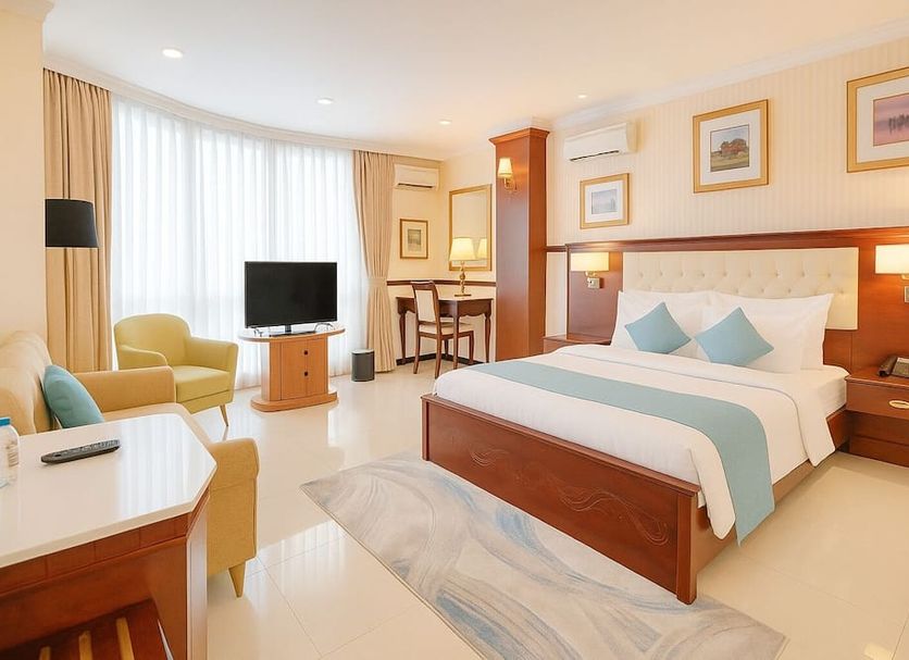 S79 Sunflower Hotel & Spa room in Ho Chi Minh City with king bed, sitting area, and TV