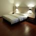 Luna Capsule in Semporna, simple guest room with double bed, wood flooring and wall-mounted lights