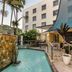 Hotel Diana Woolloongabba in Brisbane: outdoor pool beside a shaded terrace and palm trees