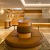 Hilton Garden Inn Mexico City Polanco lobby with circular seating, reception desk and warm lighting