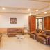 Hotel Sea View in Kanyakumari lounge with brown leather sofas, glass coffee table and curtains