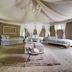 Glamping Canonici di San Marco in Mirano, safari-style tent suite with beds and draped ceiling