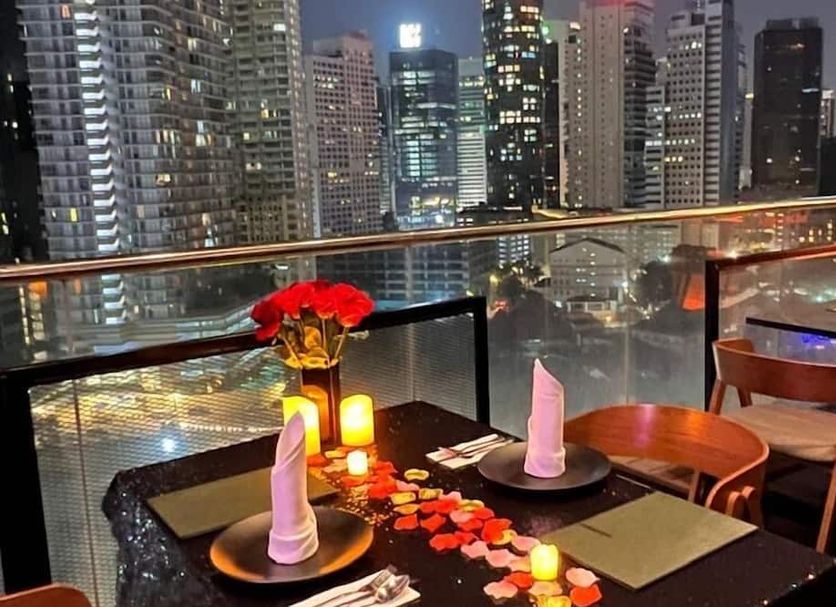 Hotel Maya Kuala Lumpur rooftop dining table with candles and city skyline view