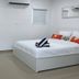 Casa Toñita in Levittown: simple guest room with bed, air conditioning, and attached bathroom