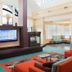 Residence Inn by Marriott Lincoln South lobby with seating area, fireplace and bright open atrium