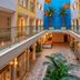 Barut B Suites in Evrenseki: interior courtyard with glass walkways, palm trees and hotel rooms