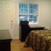 Arrowhead Mountain Inn in Lake Arrowhead room with bed, desk, window and lamp