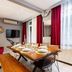 Bright Apart Hotel Istanbul dining area with set table, red curtains, wall TV, and large windows