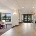 Red Roof Inn Birmingham South lobby with front desk, tiled floor, seating area and glass entrance in Birmingham