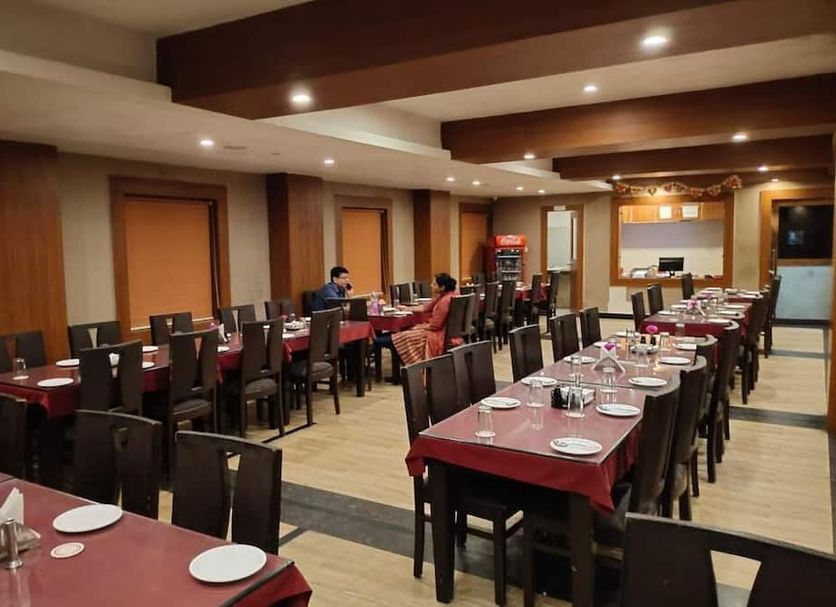 Hotel Shreehari Grand in Puri dining hall with set tables and chairs