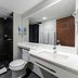 City Express by Marriott Oaxaca bathroom with walk-in shower, toilet, and vanity mirror