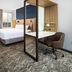 SpringHill Suites by Marriott Phoenix Goodyear guest room with king bed, desk, chair and window view