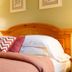 Summers Inn Ludington - Adults Only bedroom with wood headboard, bedside lamp and patterned pillows