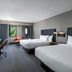 Courtyard by Marriott Cleveland Beachwood guest room with two beds, desk, window and seating area