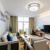 Regent Hotel Gaoyao in Zhaoqing living room with sofa, TV, desk and balcony view