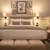 De Vere Latimer Estate bedroom in Chesham with king bed, bedside lamps, armchair and framed wall art