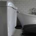 Nästegården Bed & Breakfast in Sätuna bathroom with clawfoot bathtub beside a toilet and tiled wall