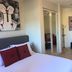 Studio Suite at Marina Cabo Plaza in Cabo San Lucas with bed, lounge area, and sliding glass door